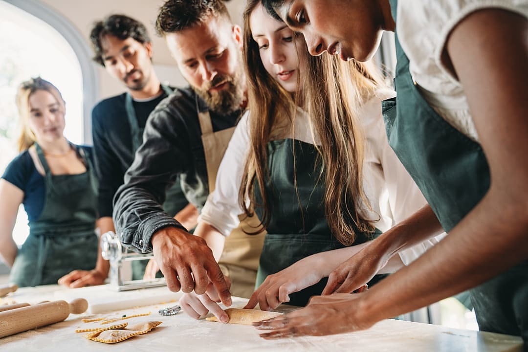 Guests enjoying a pasta making class, Italy.