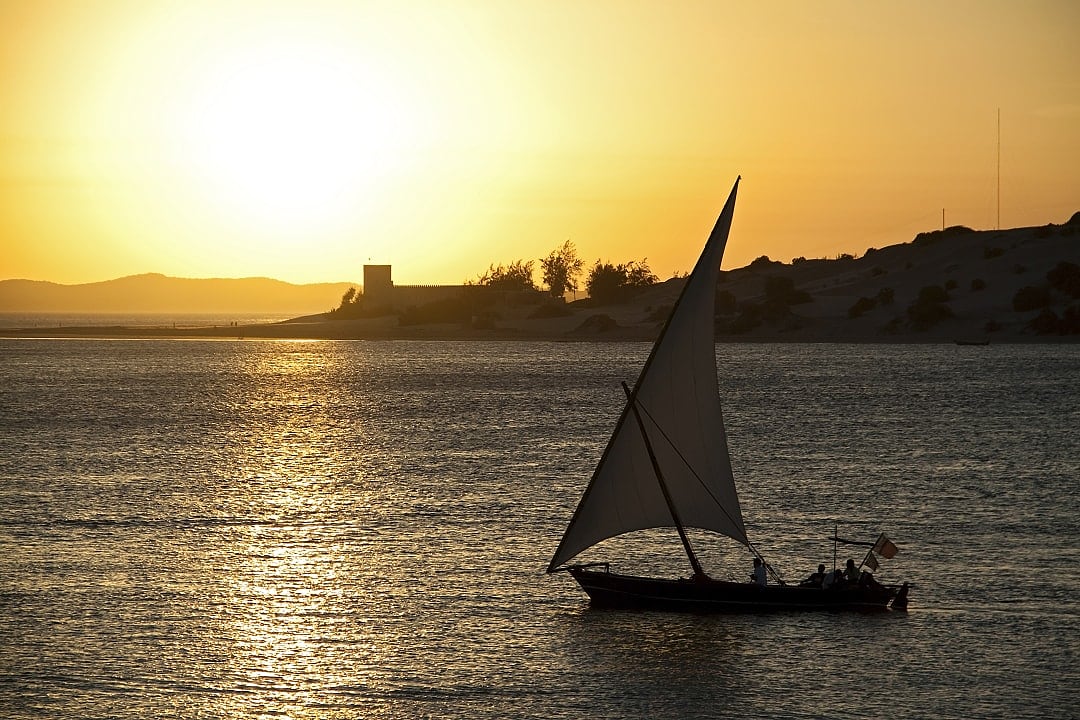 Dhow sailing at sunset in Lamu Island, Kenya