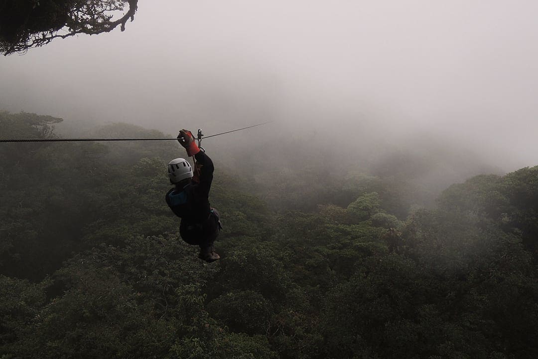 Woman canopy touring above the rainforest in Costa Rica.