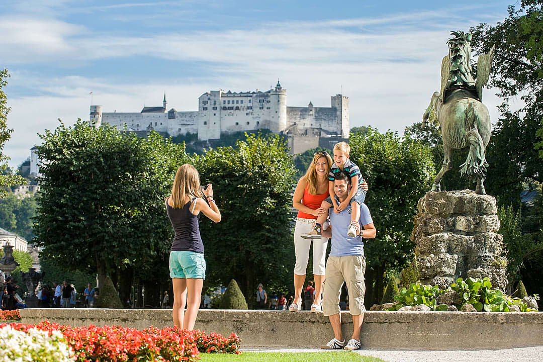 Family at the Mirabellgarten with view of Fortress Hohensalzburg in Salzburg