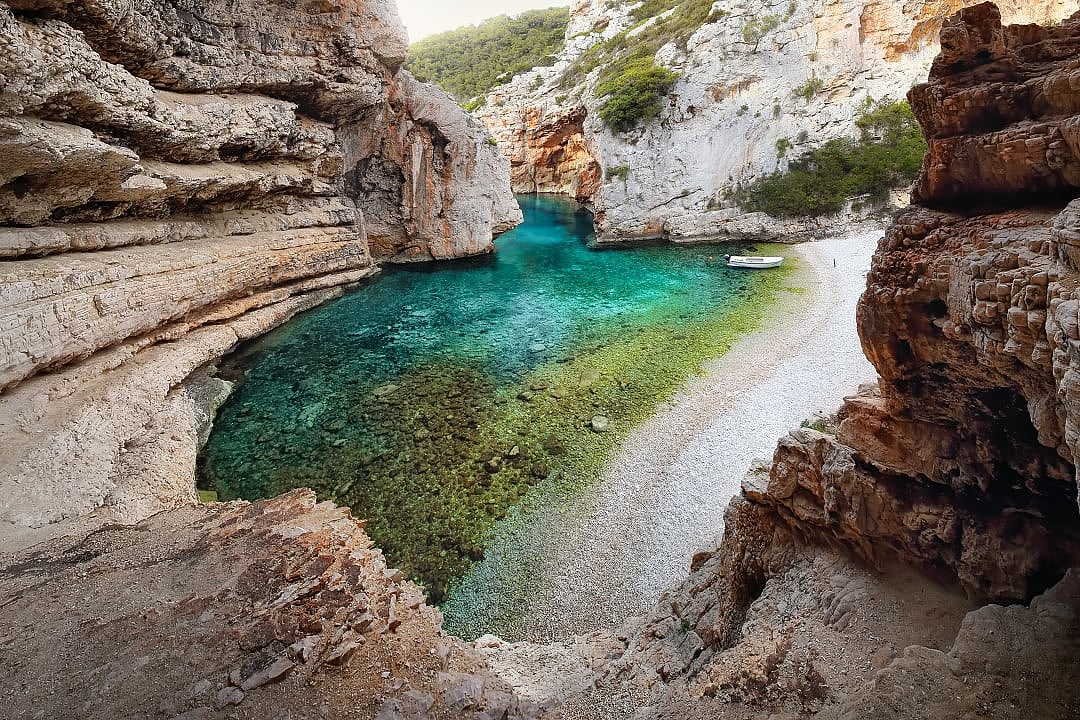 Stiniva Beach on Vis Island features a stunning secluded cove.