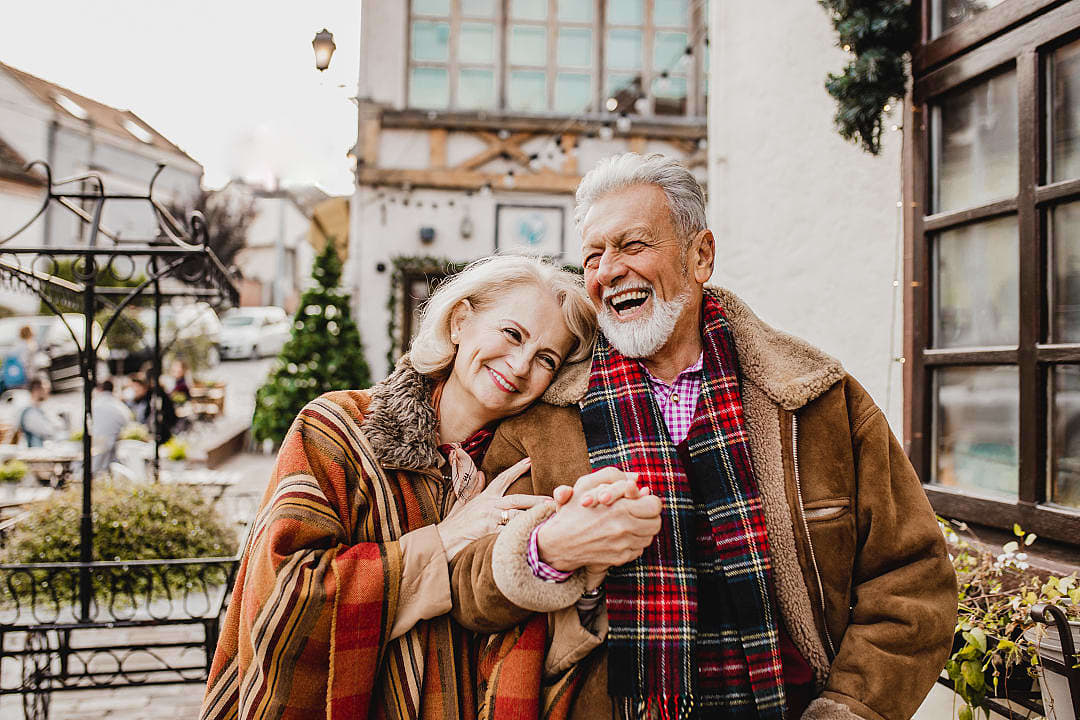 Happy senior couple enjoying a winter day in a charming European village