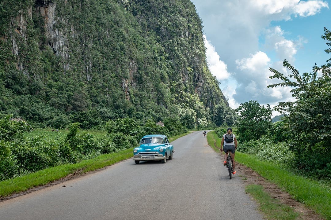 Female traveler riding on the bike in Vinales, Cuba