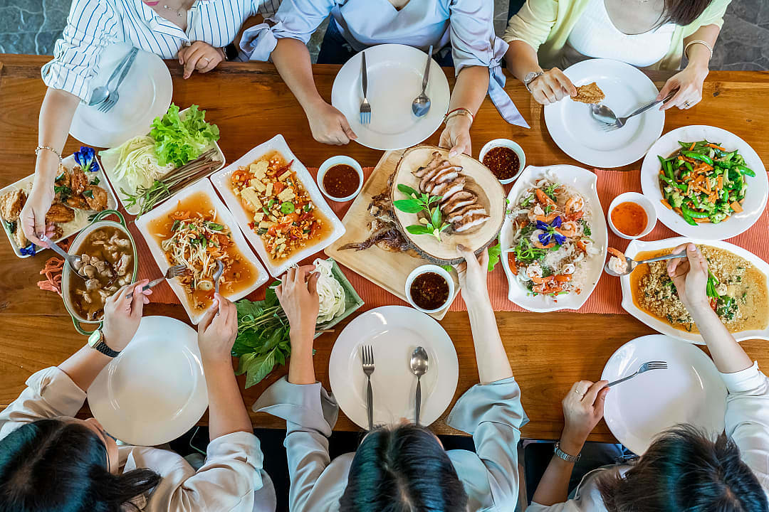 Group of friends sharing a meal in Thailand