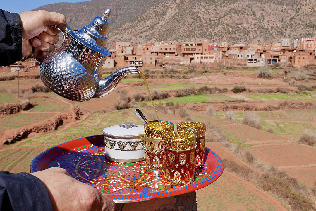 Man pouring Moroccan tea in the berber village of Tizi N'oucheg in Ourika Valley, High Atlas Mountains
