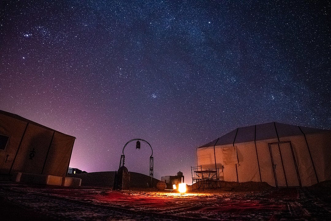 Starry night sky over luxury camp in the Sahara Desert, Morocco