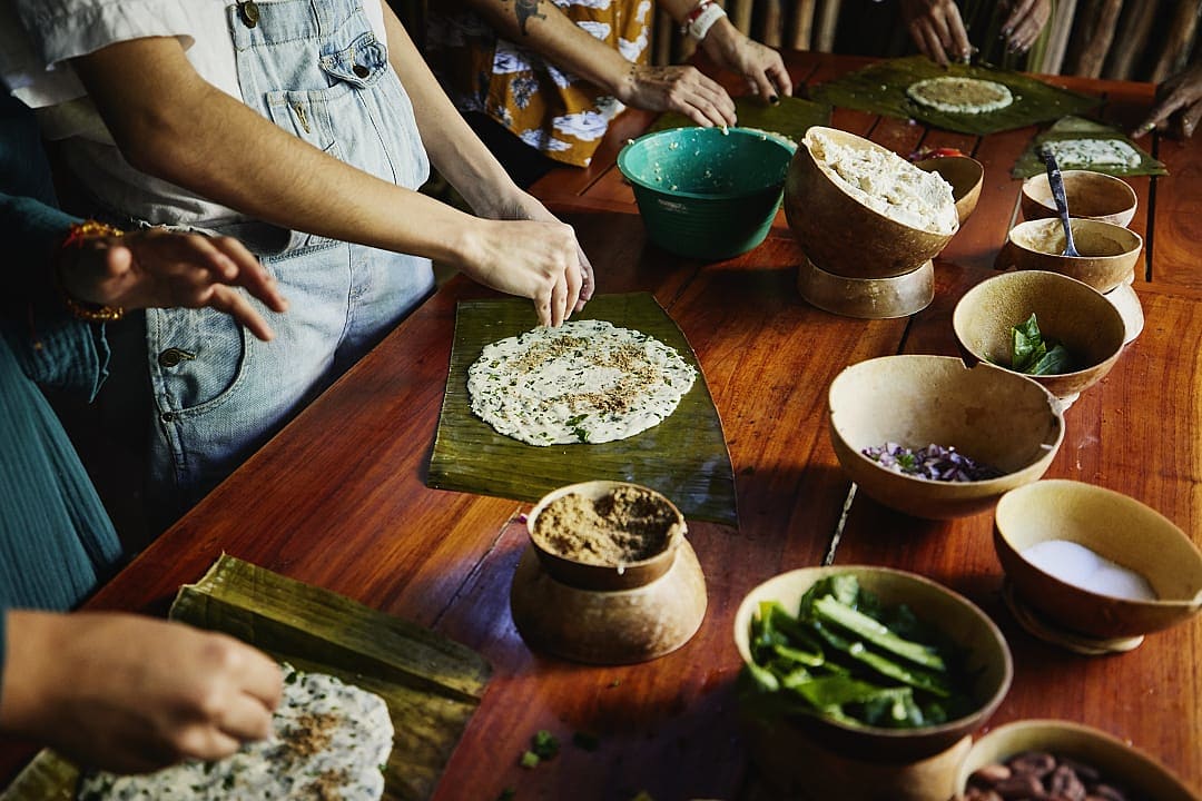 Women learing to make tamales during a Mayan cooking class in Mexico