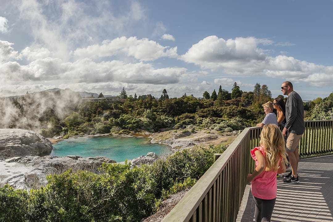 Family at geothermal lake in Rotorua, New Zealand
