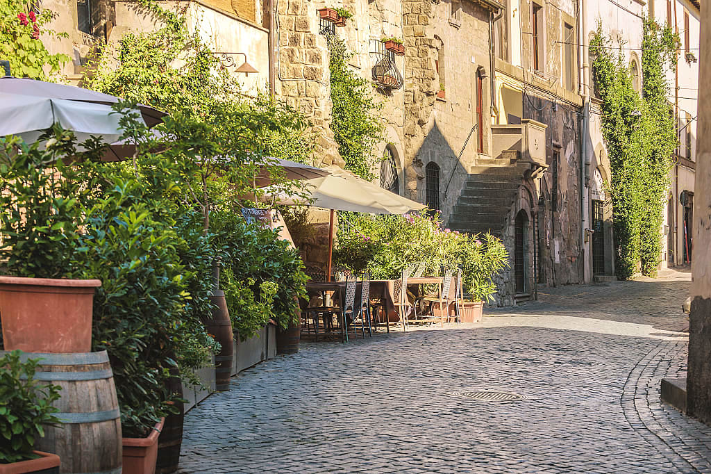 Narrow street with restaurant in Viterbo, Italy