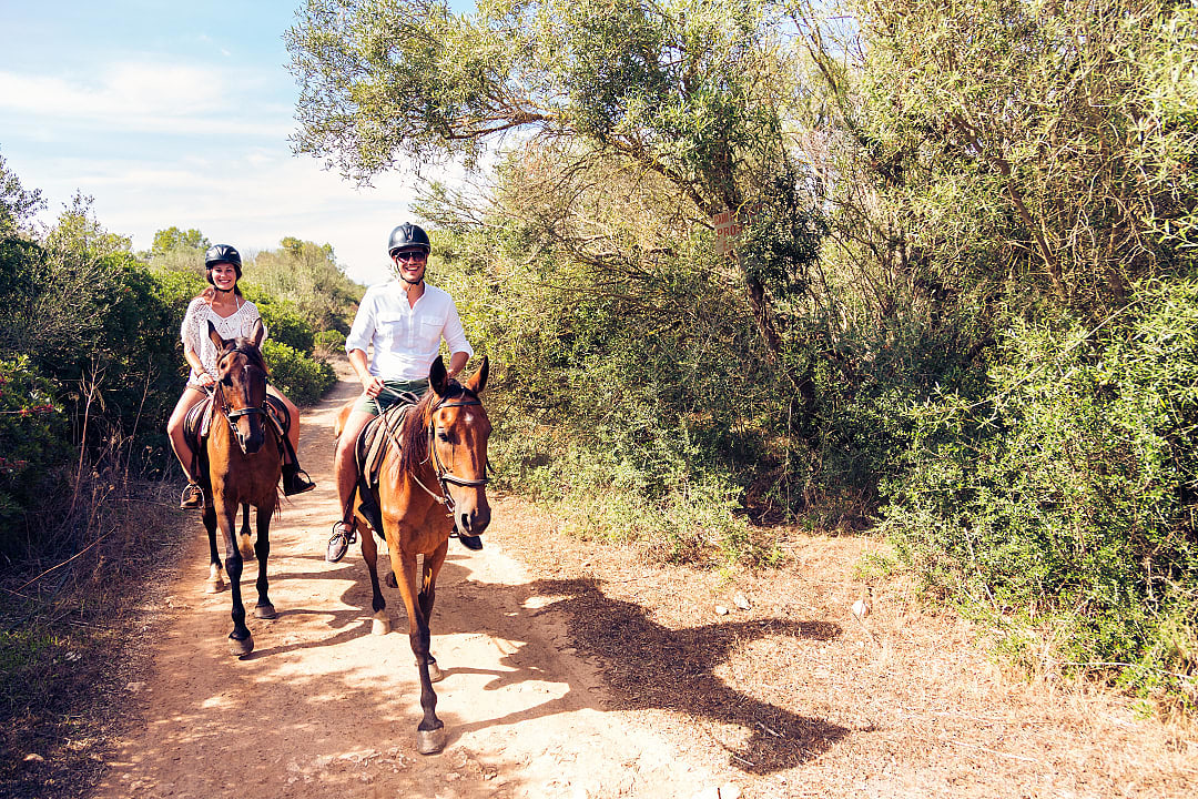 Couple horseback riding in Mallorca, Spain