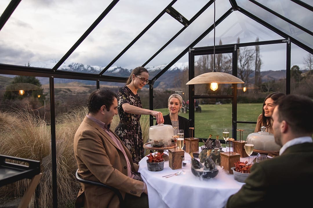 Travelers enjoying multi-course luxury meal in Queenstown, New Zealand