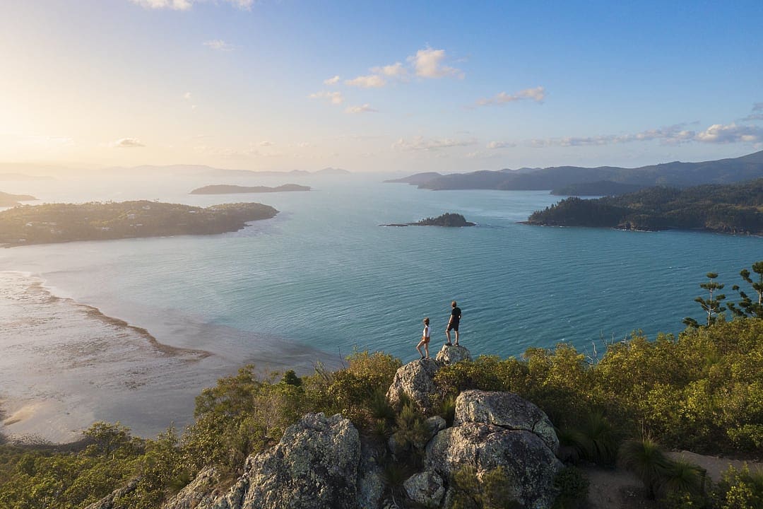 Hikers exploring the serene Whitsunday Island.
