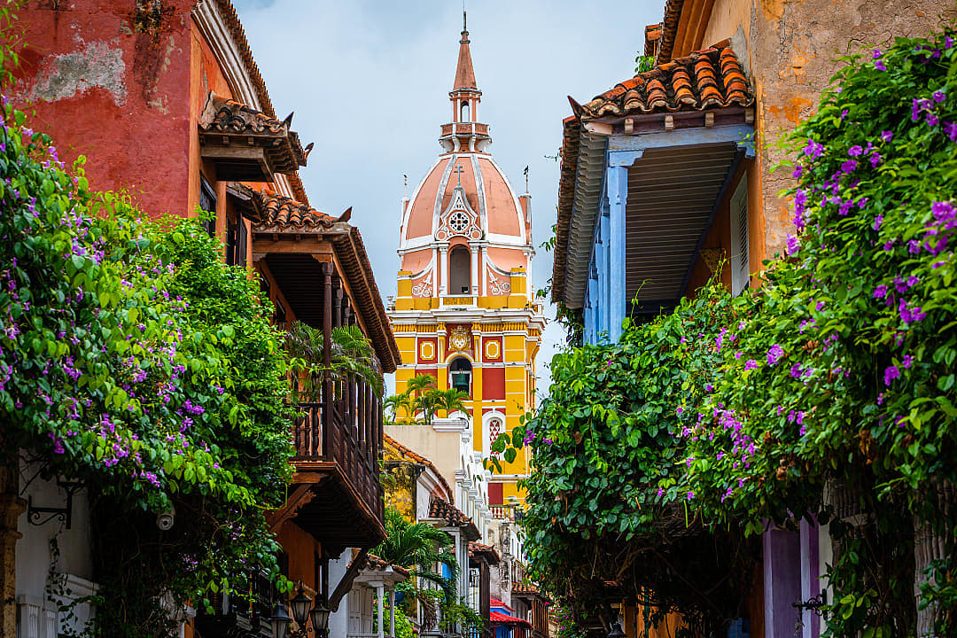Flower-lined street leading to Torre del Reloj in Cartagena’s historic Old Town, Colombia