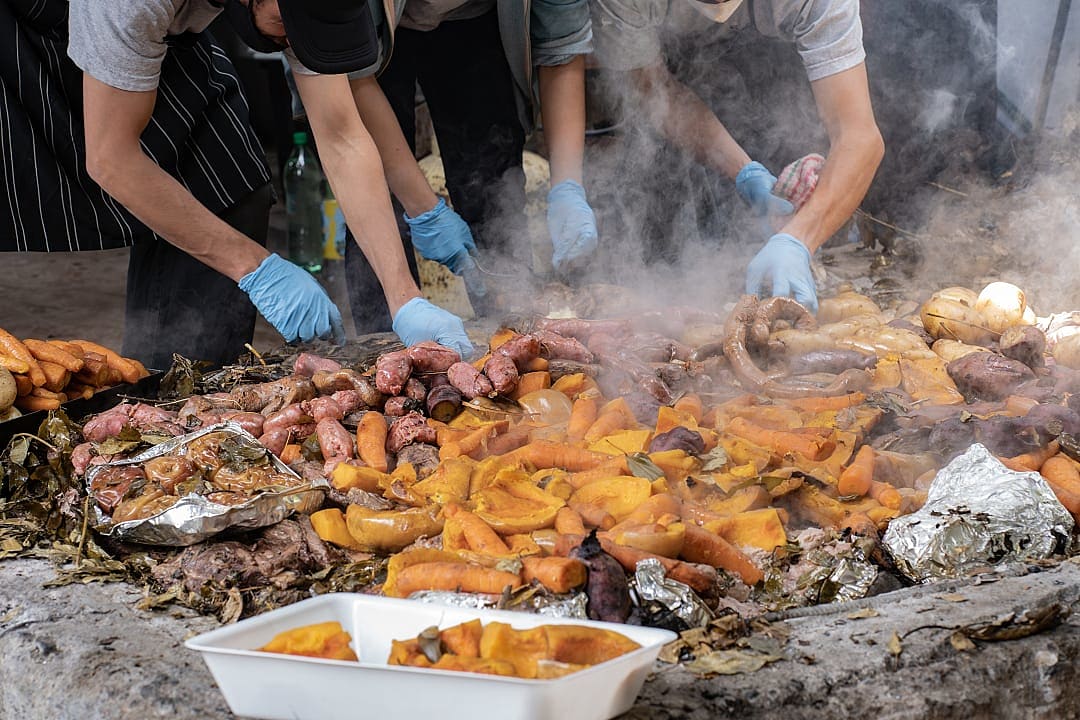 Chefs uncover steaming curanto, a traditional Patagonian feast cooked underground.