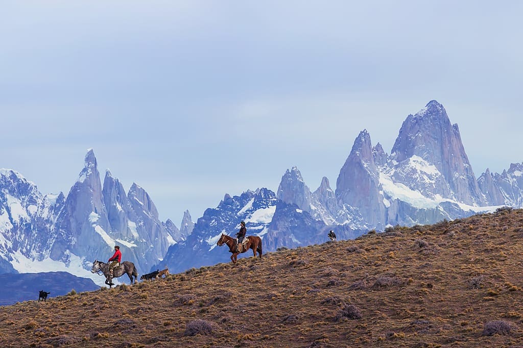 Gauchos riding against the background of Mount Fitz roy, Patagonia, Argentina,