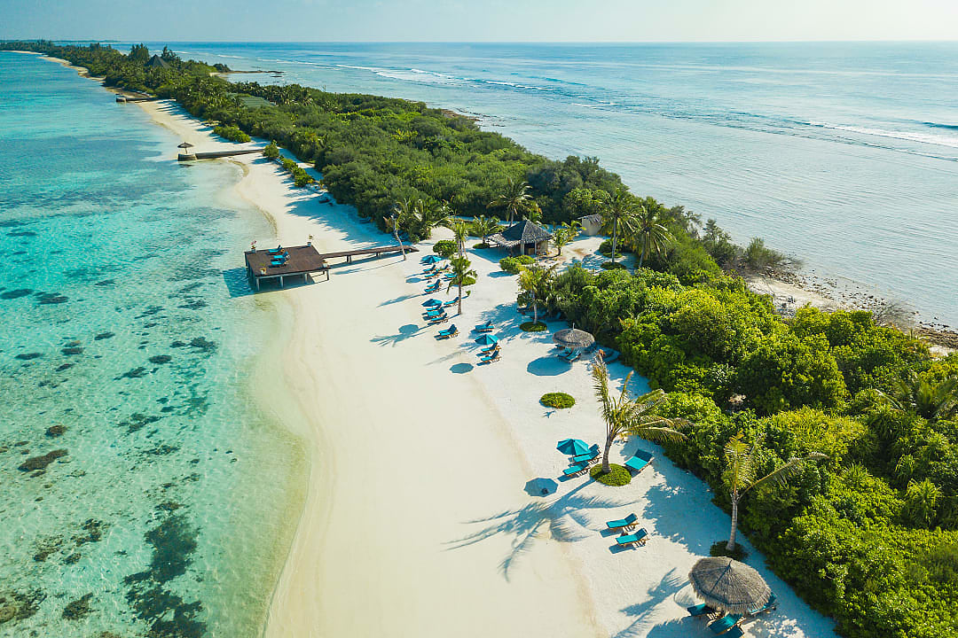 Tropical beach resort in the Maldives, featuring white sands and turquoise waters.
