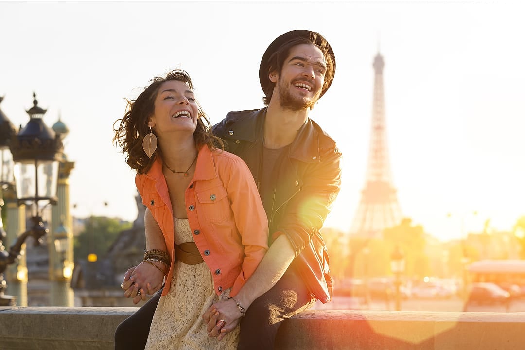 Couple in Paris with Eiffel Tower in the background at sunset