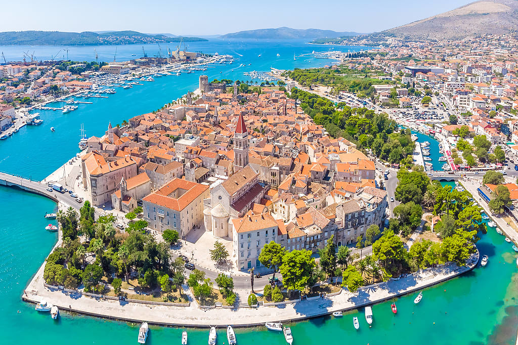 Birds eye perspective on historic Trogir, Croatia,  in summer with turquoise bay waters and mountains