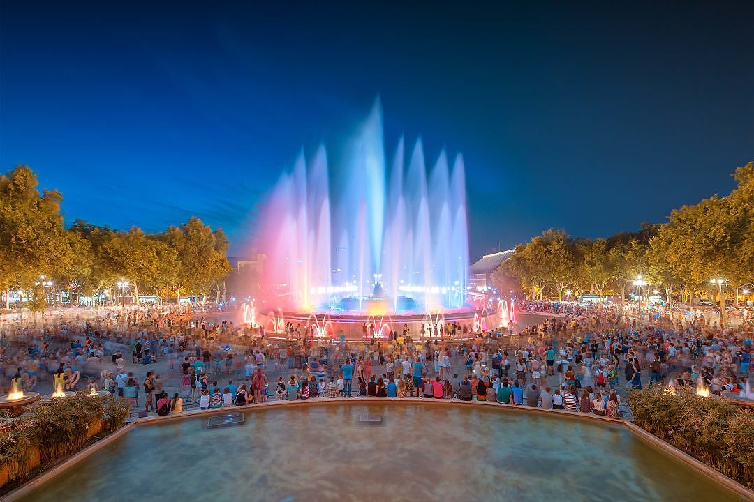 People watching the Magic Fountain at night in Barcelona, Spain