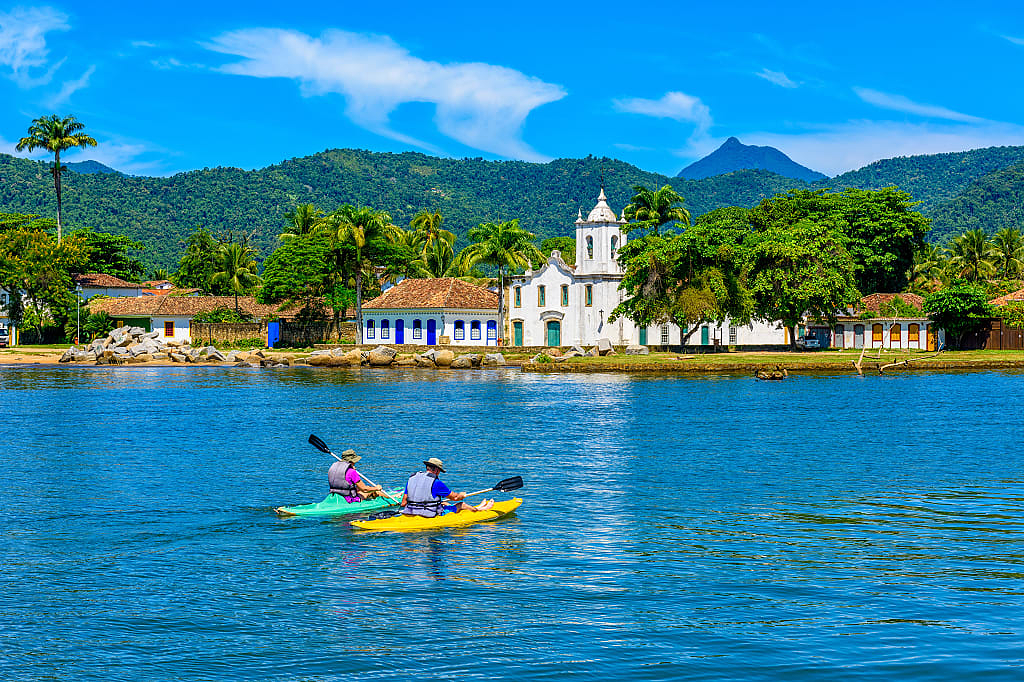 Couple kayaking in Paraty in Rio de Janeiro, Brazil.
