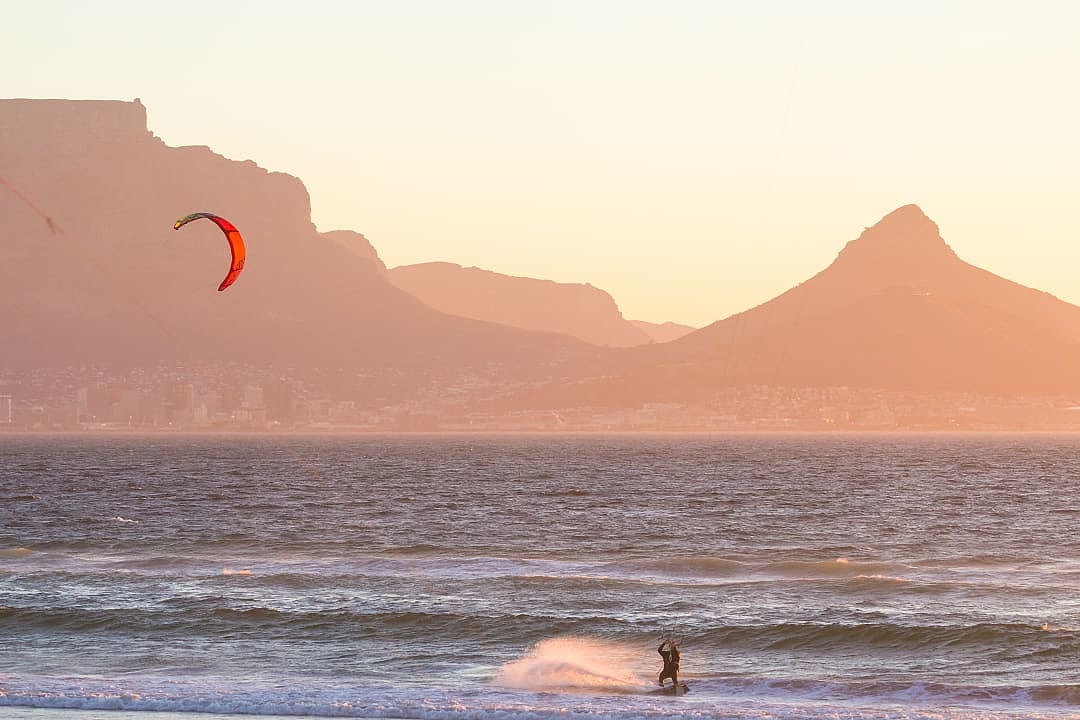 Kitesurfing at sunset in Cape Town, South Africa