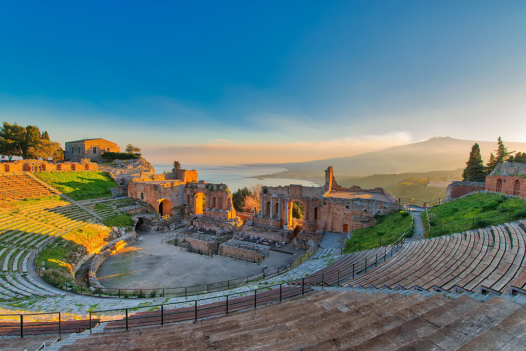 Ancient theatre of Taormina in Sicily with Mount Etna in the background
