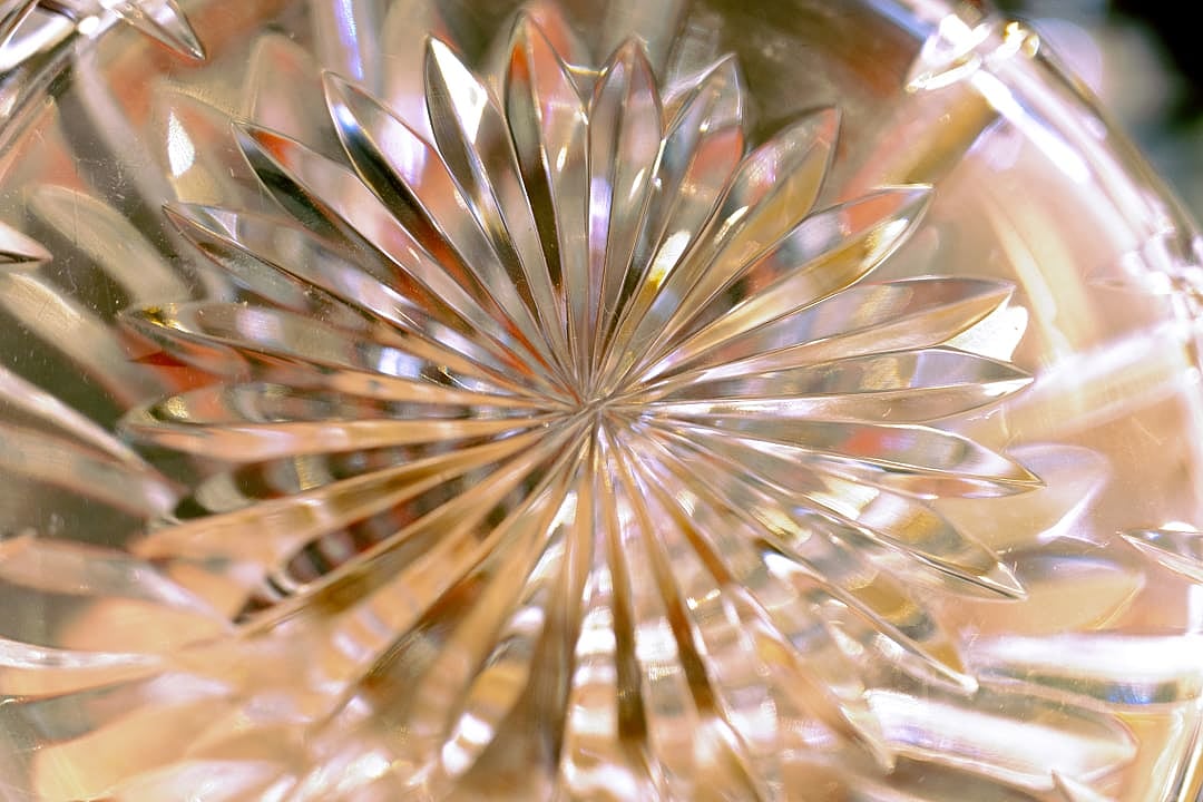 Close up showcasing the bottom of cut crystal glass.