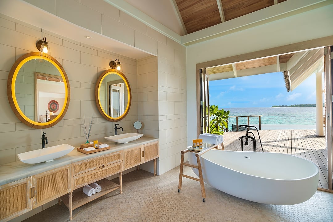 Elegant villa bathroom opens to ocean views on Milaidhoo Island paradise.