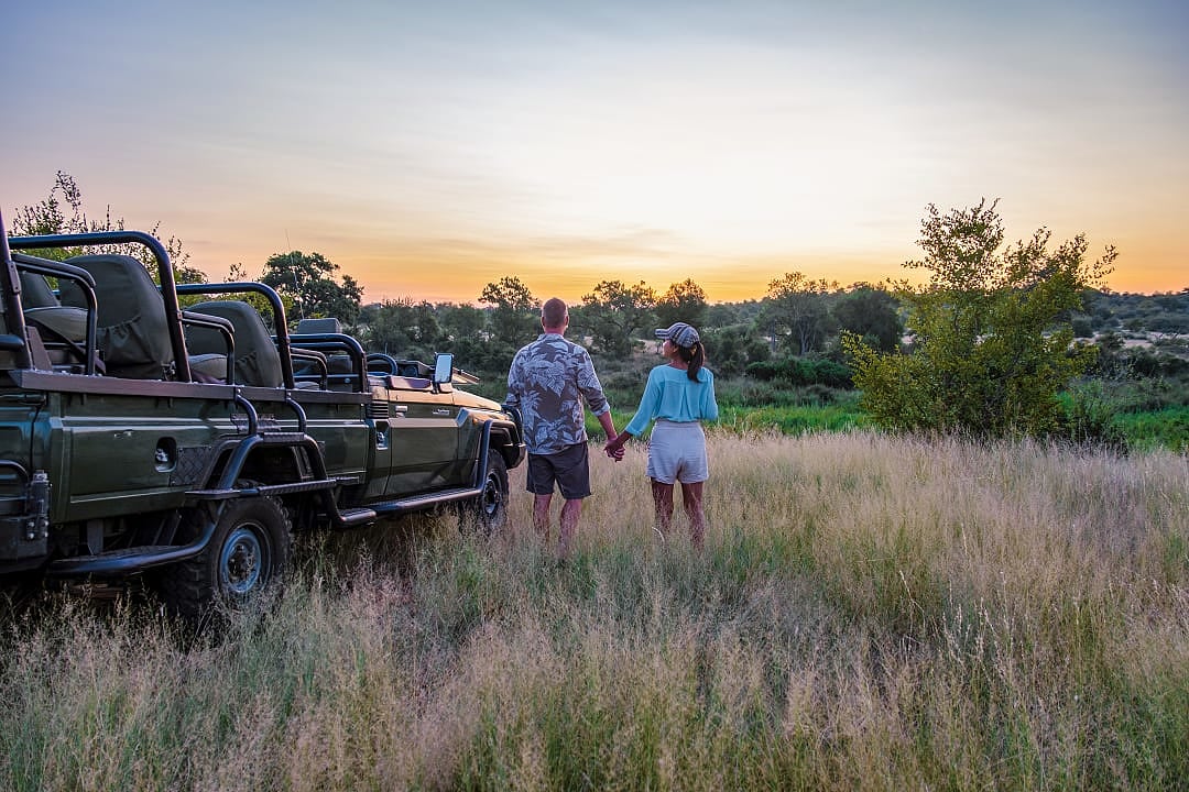 A couple enjoying the sunset, during a safari game drive in the Klaserie Private Nature Reserve.