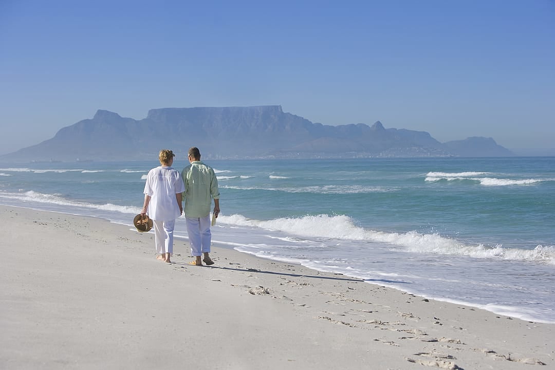 Senior couple walking together on the beach in Cape Town, South Africa