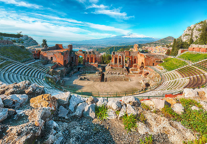 Ruins of an ancient Greek theater. View of Mount Etna. Tarmina, Sicily