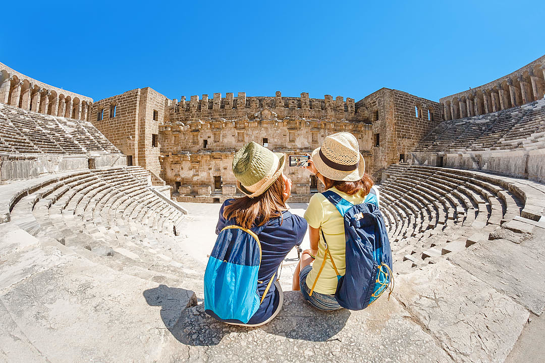 Two young girls taking selfie at Aspendos Theater in Antalya, Turkey