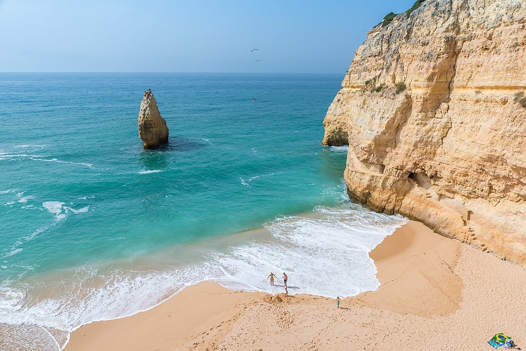 Family at beautiful beach Praia do Carvalho in the Algarve, Bengil, Portugal