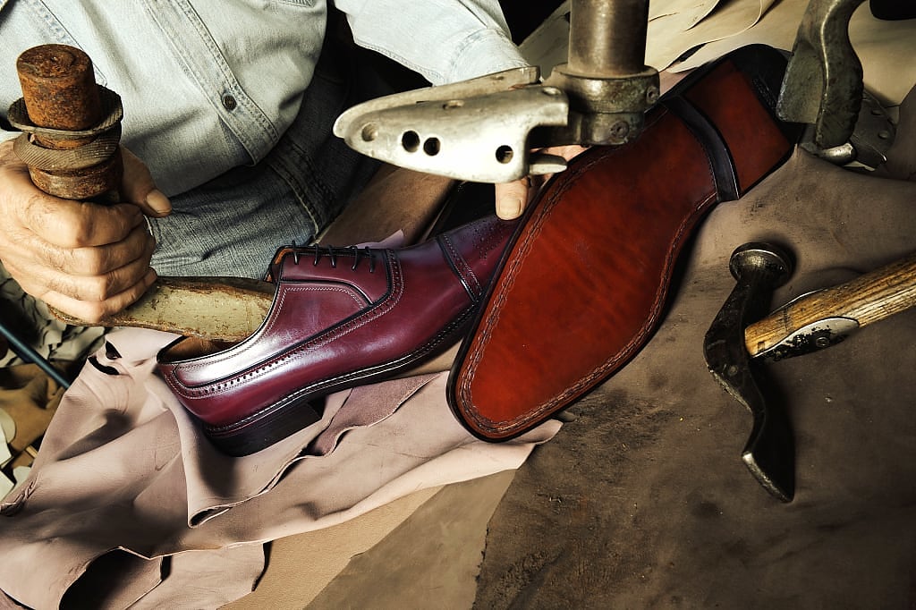 Italian cobbler making luxury leather shoes