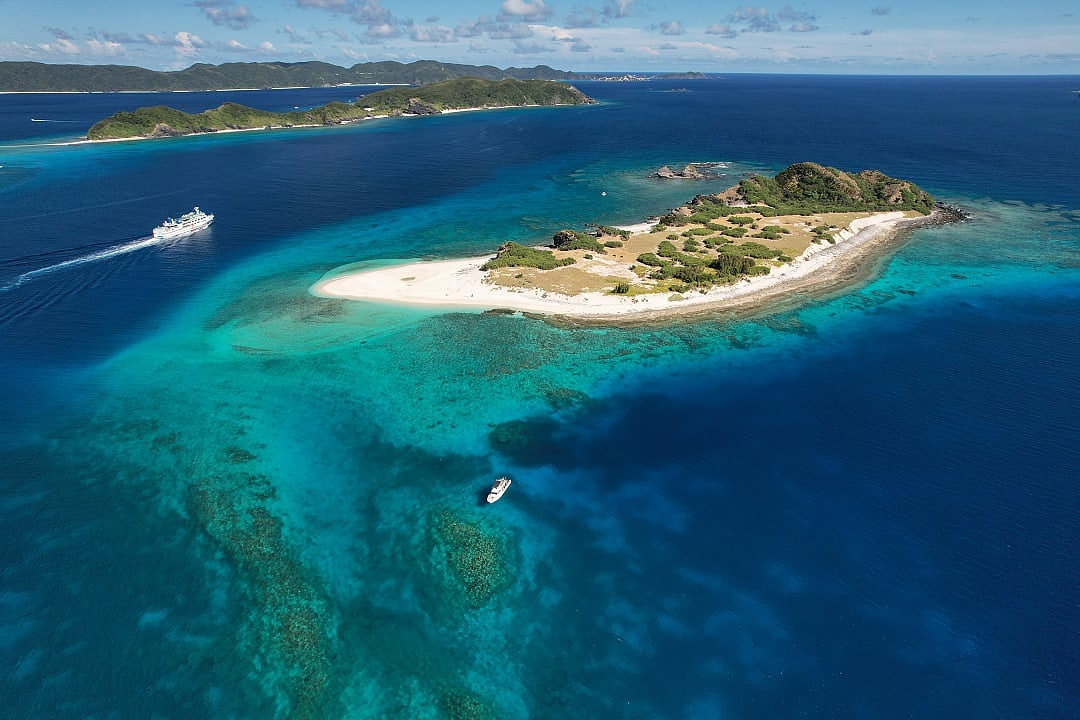 Aerial view of white sand beach and coral reefs at Zamami Island in the Kerama Islands, Okinawa, Japan