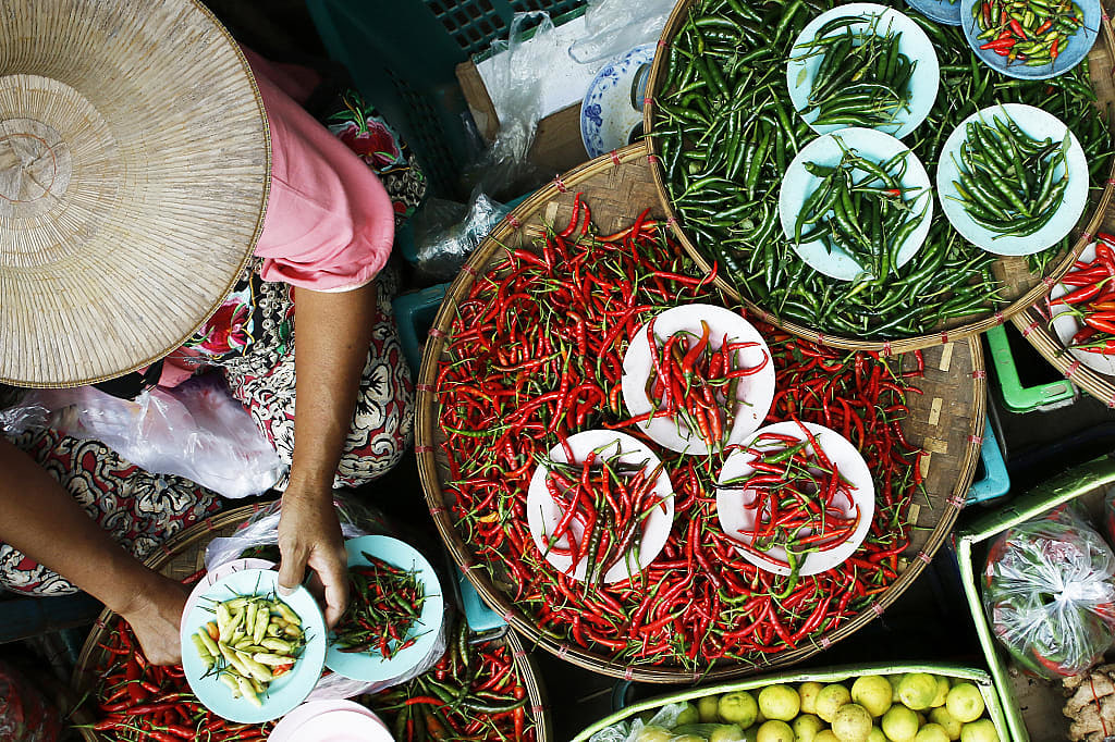 Woman selling peppers at market in Vietnam