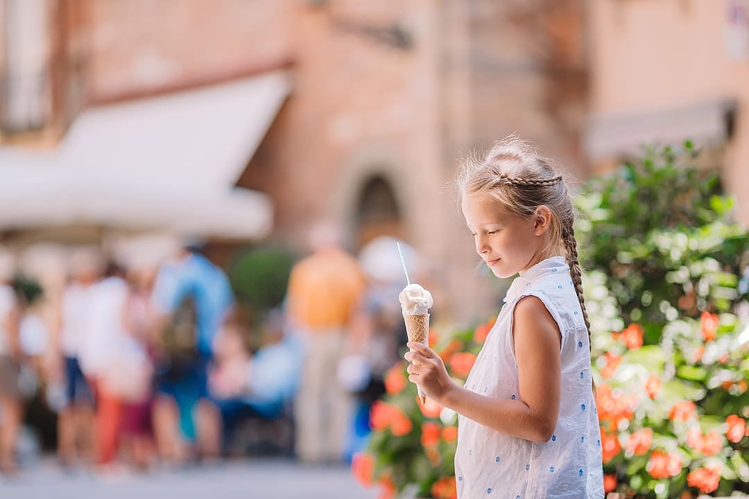 Young girl holding an artisanal gelato, Florence.