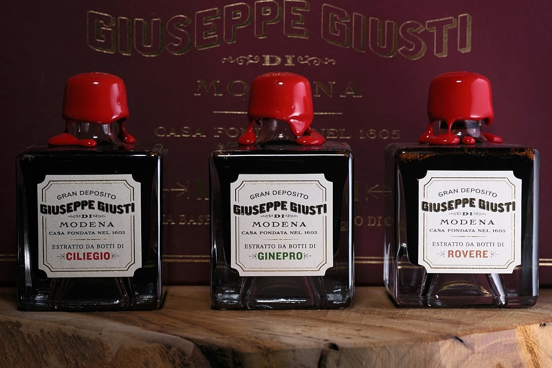 Bottles of Giuseppe Giusti balsamic vinegar from Modena, aged in cherry, juniper, and oak barrels