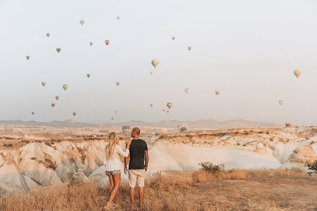 Couple looking at hot air balloons in Cappadocia, Turkey