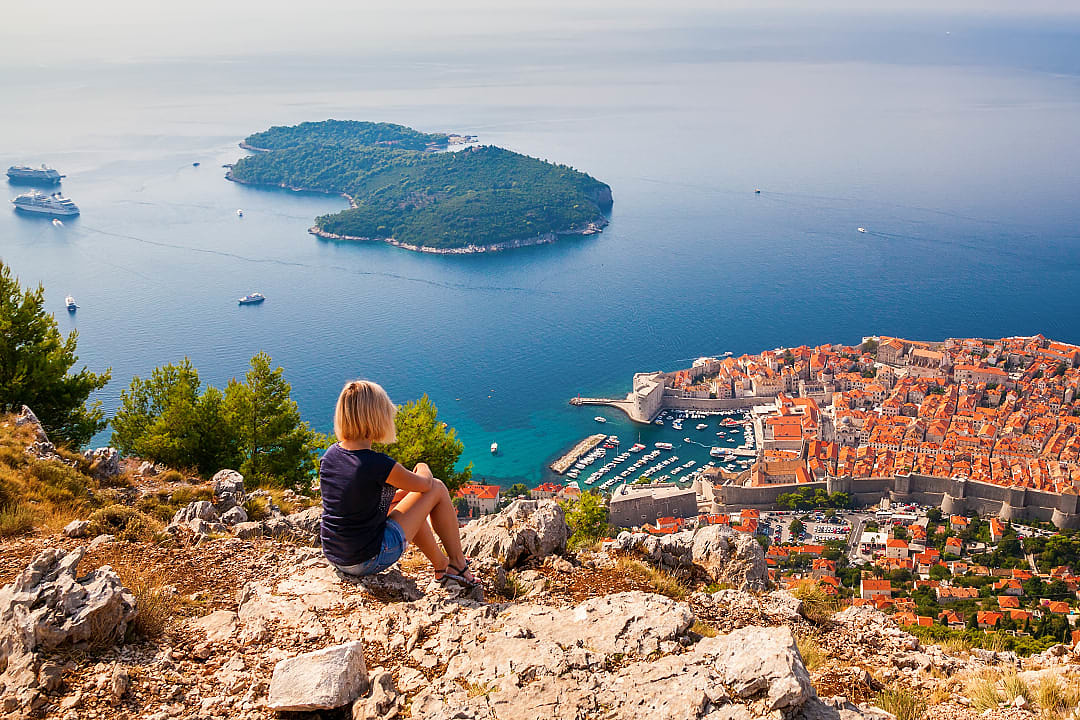 Woman enjoying the view of Old Town in Dubovnik, Croatia