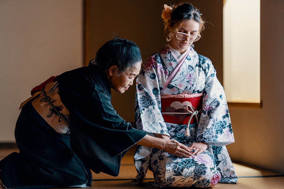 Traditional Japanese tea ceremony instruction in a tatami room.