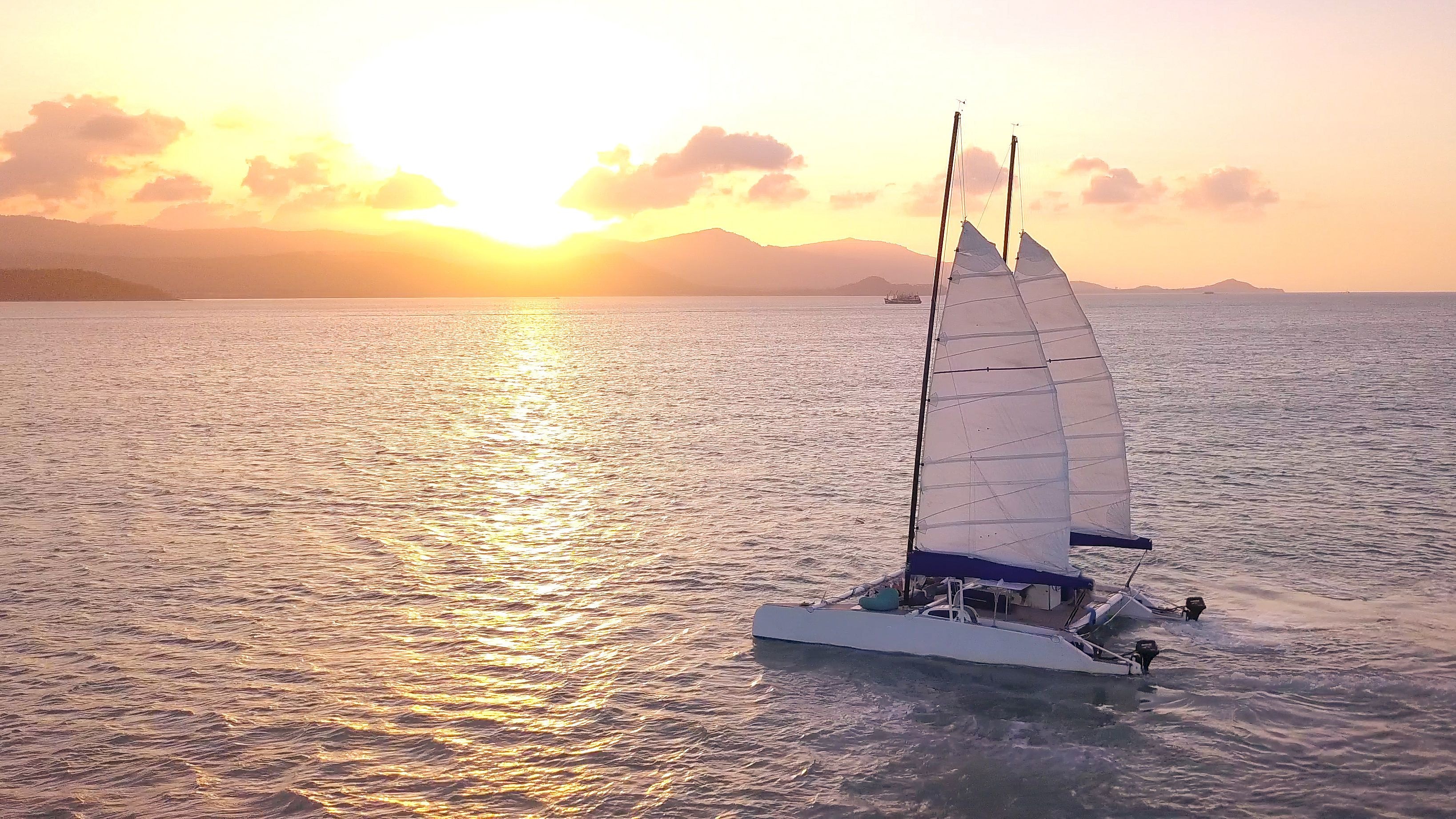 Catamaran sailing at sunset near Koh Samui