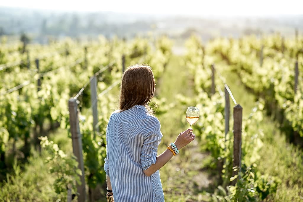 A woman holding a glass of wine in Bordeaux, France