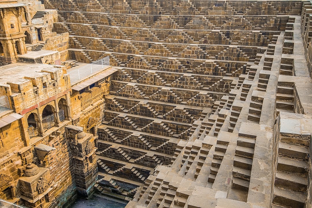 Intricate geometric steps of Chand Baori stepwell showcasing ancient architectural design.