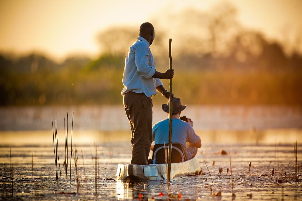 Mokoro boat meandering down the river in the Okavango Delta, Botswana