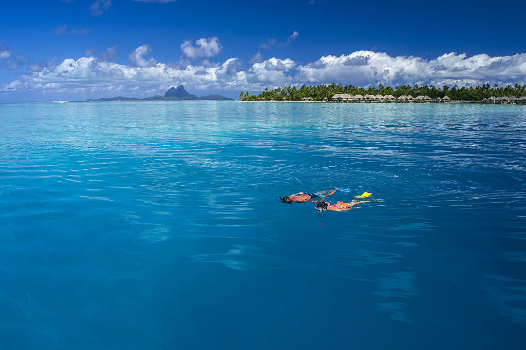 Couple snorkeling in Tahaa, Tahiti.  Photo by David Kirkland, courtesy of Tahiti Tourisme