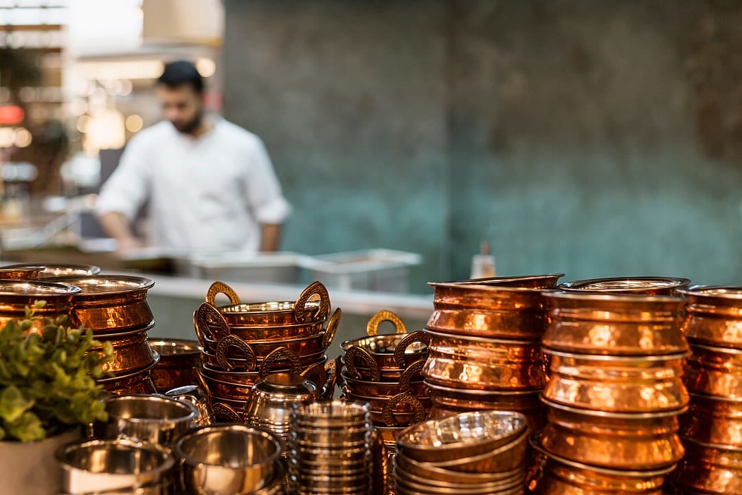 Traditional brass pots at a restaurant in Mumbai.