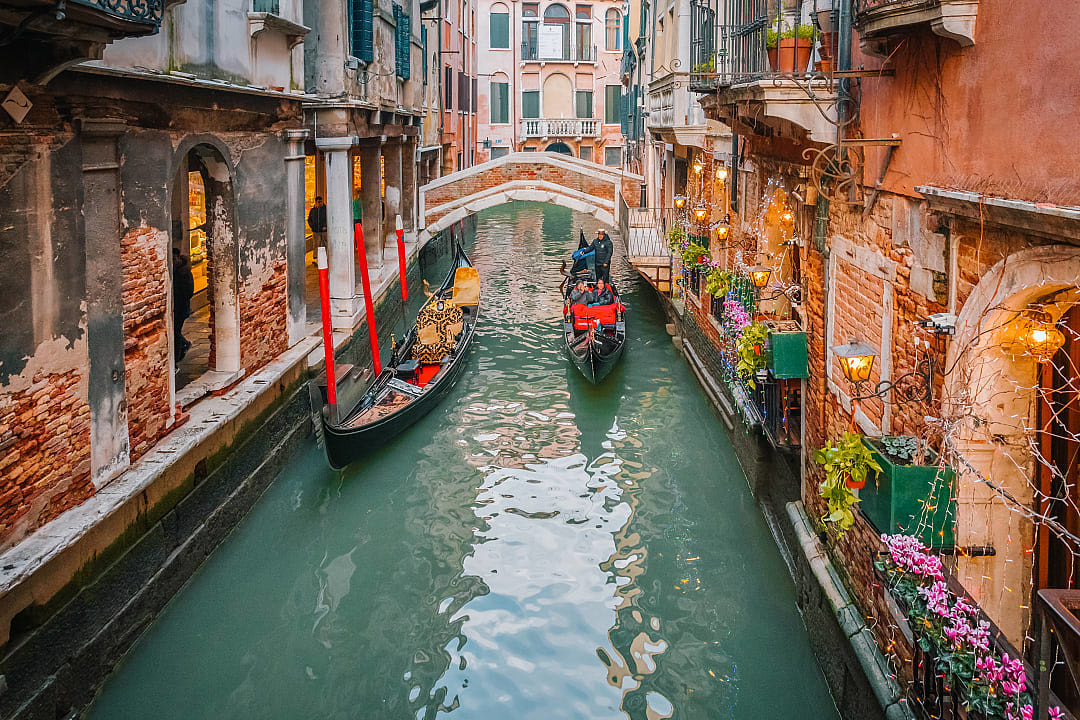 Couple enjoying gondola ride during winter in Venice, Italy