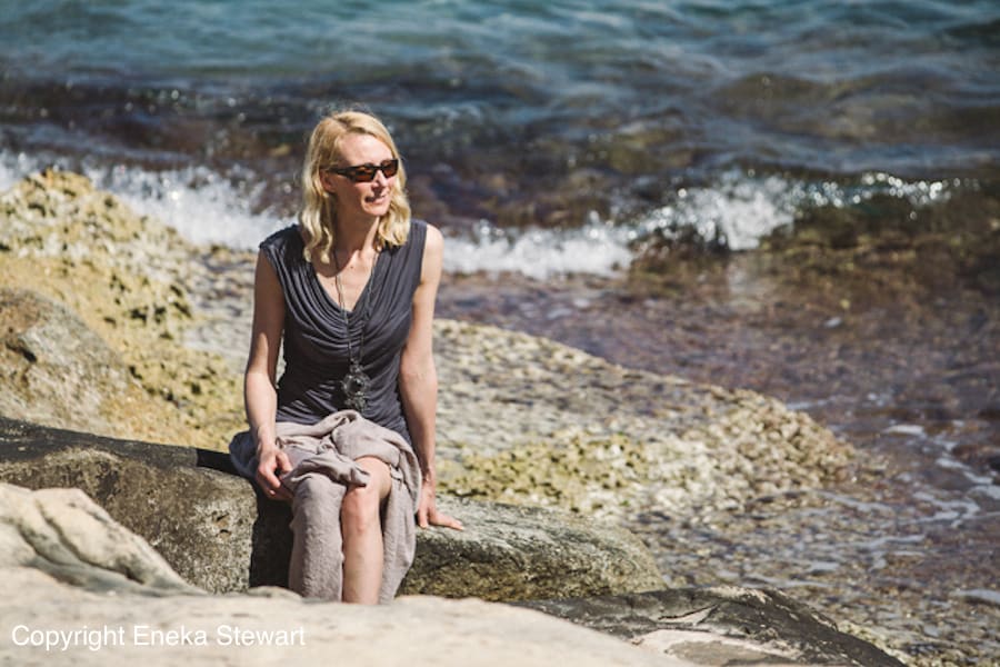 Woman sunbathing on a rock