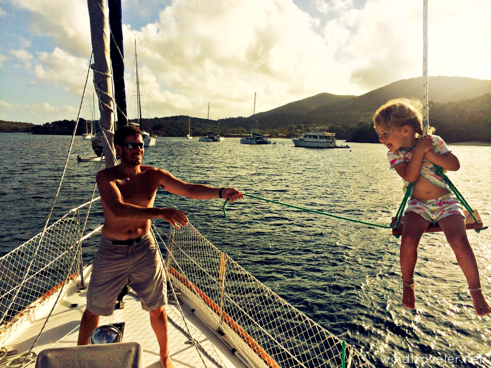 girl and dad on a sailing boat read the sailing blog